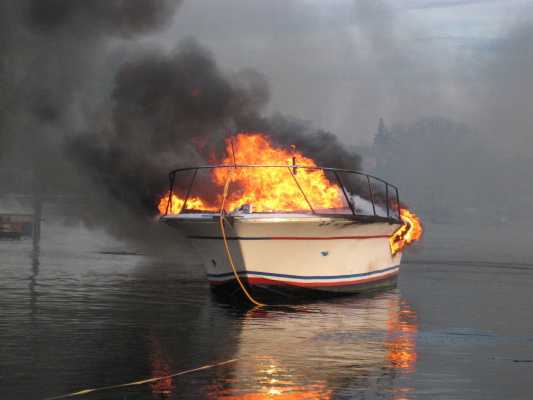 A fire on a cargo ship destroyed two luxury yachts